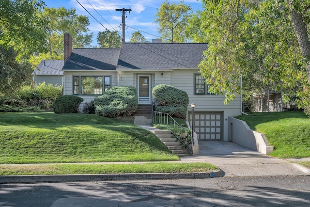 view of front facade with a front yard and a garage