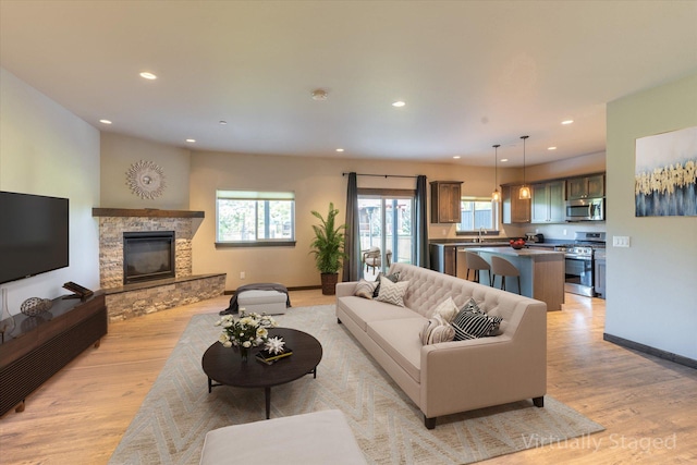 living room featuring a fireplace and light hardwood / wood-style flooring