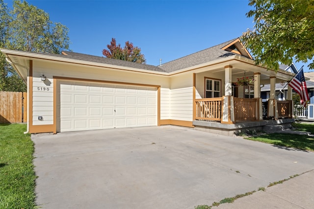 ranch-style house featuring covered porch and a garage