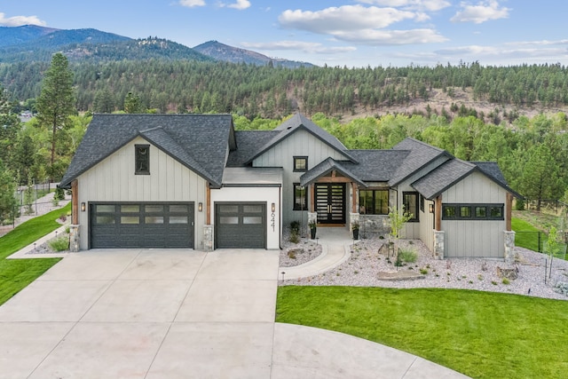 modern farmhouse style home featuring a mountain view and a front yard