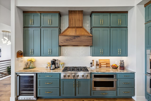 interior space with tasteful backsplash, beverage cooler, stainless steel gas stovetop, custom range hood, and light wood-type flooring