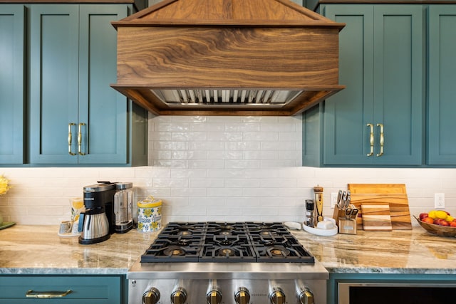 kitchen with custom range hood, decorative backsplash, stainless steel range oven, and light stone countertops