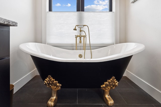 bathroom featuring a bath and tile patterned floors