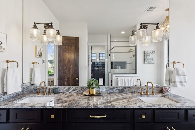 bathroom with walk in shower and vanity