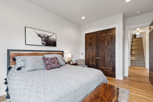 bedroom featuring wood-type flooring and a closet