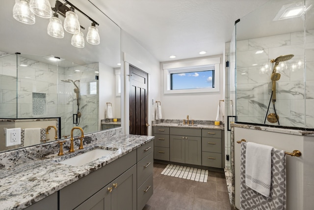 bathroom with vanity and a shower with door