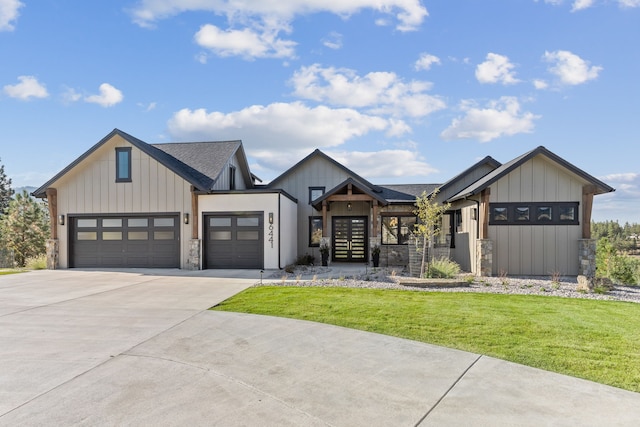 modern farmhouse style home with a front yard and a garage