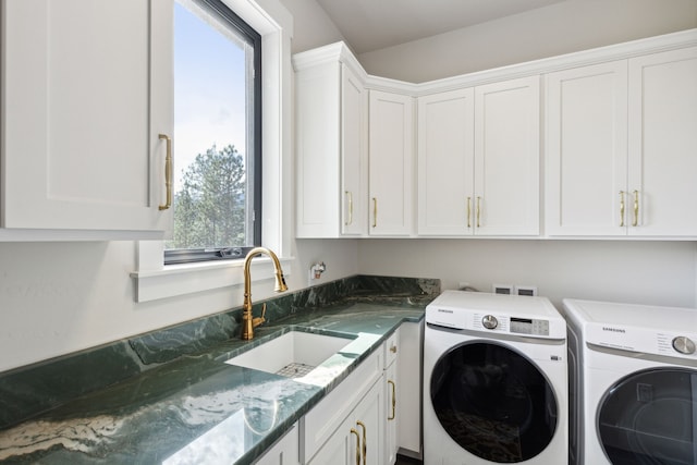 laundry room featuring sink, independent washer and dryer, and cabinets