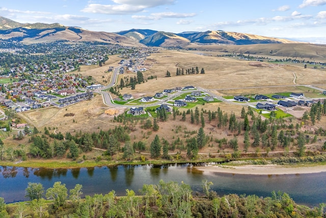 drone / aerial view featuring a water and mountain view