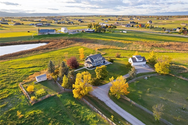 bird's eye view with a water view and a rural view