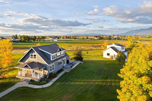 drone / aerial view featuring a mountain view and a rural view