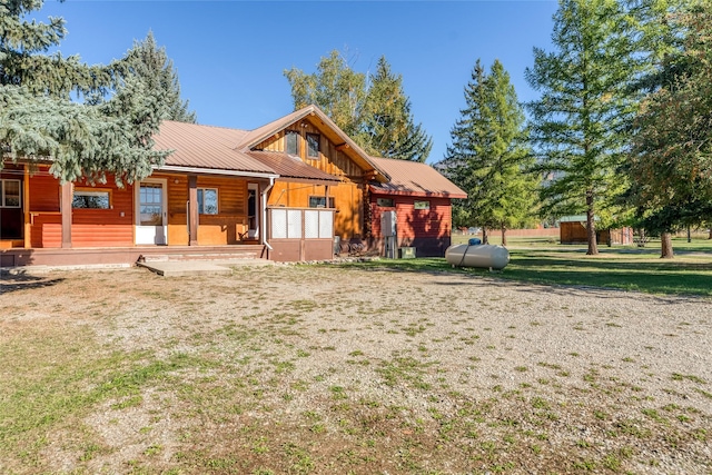 2237 Grave Creek Rd, Eureka, MT 59917 - view of front of house featuring a metal roof, a front lawn, and a porch