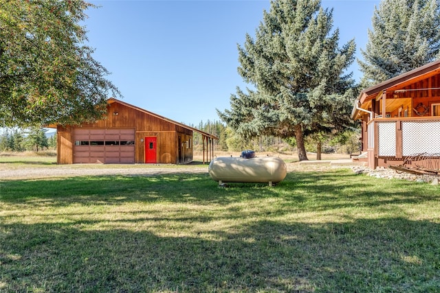 2237 Grave Creek Rd, Eureka, MT 59917 - view of green lawn with a detached garage and an outdoor structure