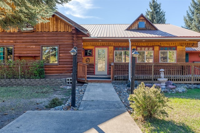 2237 Grave Creek Rd, Eureka, MT 59917 - view of front of house featuring covered porch, a metal roof, and log exterior