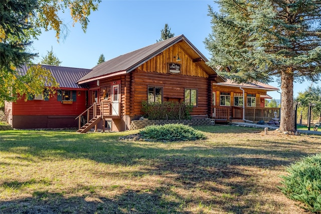 2237 Grave Creek Rd, Eureka, MT 59917 - rear view of house featuring a yard, a metal roof, and log siding