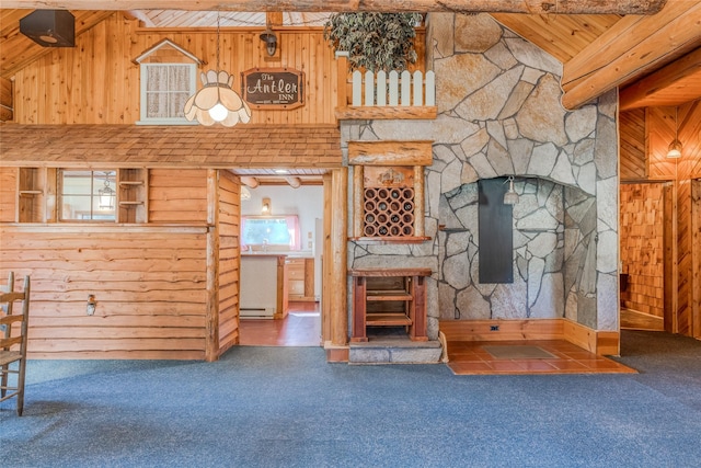 2237 Grave Creek Rd, Eureka, MT 59917 - unfurnished living room with wood walls, carpet, and wooden ceiling