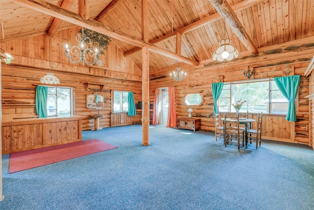 2237 Grave Creek Rd, Eureka, MT 59917 - carpeted living room featuring a chandelier, rustic walls, a wooden ceiling with exposed beams, and high vaulted ceiling