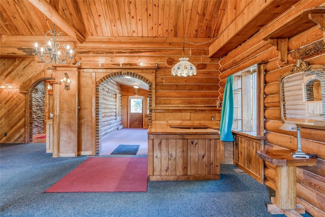 2237 Grave Creek Rd, Eureka, MT 59917 - kitchen featuring arched walkways, log walls, carpet floors, a chandelier, and a wooden ceiling with exposed beams