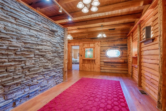 2237 Grave Creek Rd, Eureka, MT 59917 - entryway featuring a wood ceiling with exposed beams, track lighting, wood-type flooring, and a chandelier