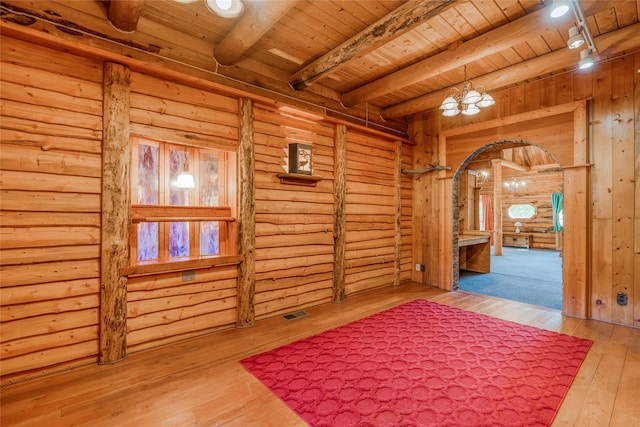 2237 Grave Creek Rd, Eureka, MT 59917 - corridor with a wood ceiling with exposed beams, arched walkways, hardwood / wood-style flooring, and a chandelier