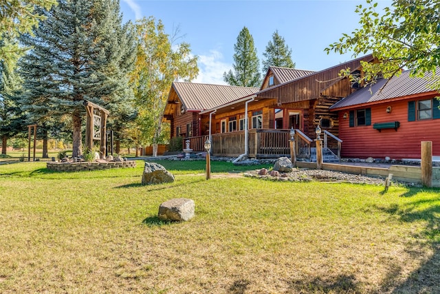 2237 Grave Creek Rd, Eureka, MT 59917 - rear view of property with a metal roof, a lawn, and log siding