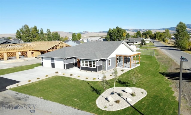 view of front facade featuring a mountain view and a front lawn