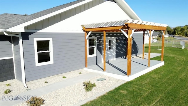 rear view of property with a yard and a pergola