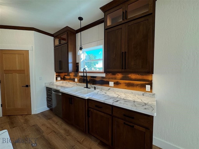 kitchen with hanging light fixtures, sink, dishwasher, light stone countertops, and dark hardwood / wood-style flooring