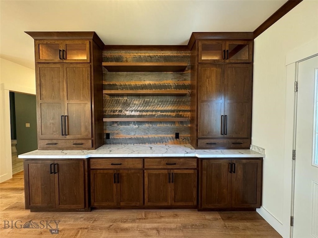 kitchen featuring light stone countertops and light hardwood / wood-style floors