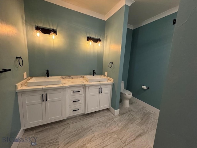 bathroom with ornamental molding, vanity, and toilet