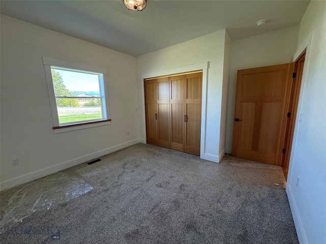 unfurnished bedroom with carpet floors and a closet