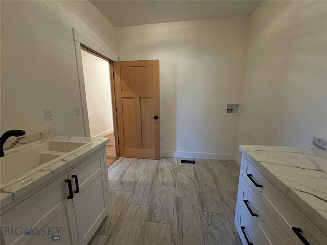 bathroom featuring wood-type flooring and sink