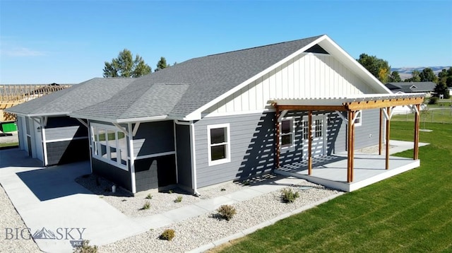 rear view of house with a sunroom, a yard, and a patio area