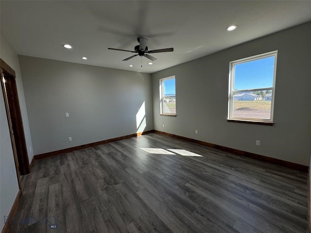 spare room featuring ceiling fan and dark hardwood / wood-style flooring