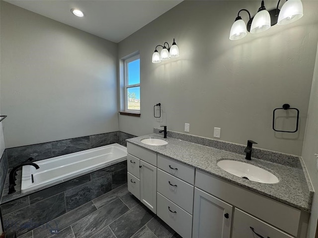 bathroom with tiled bath and vanity