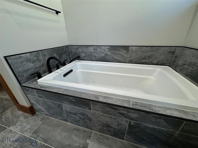 bathroom featuring tiled tub