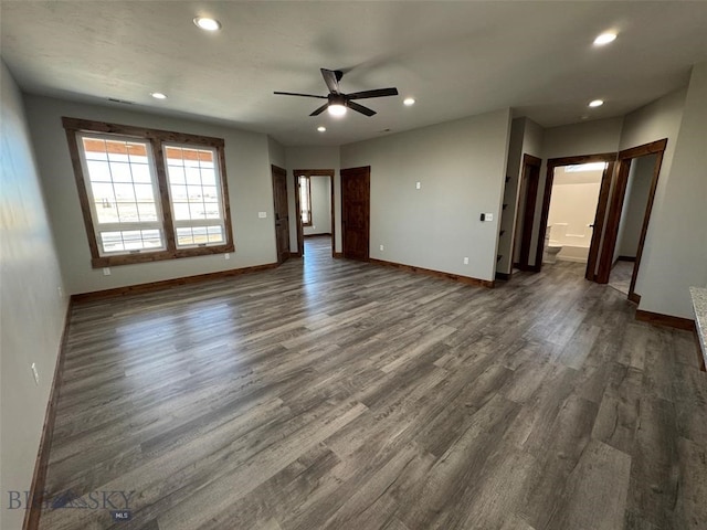 spare room with ceiling fan and dark hardwood / wood-style floors