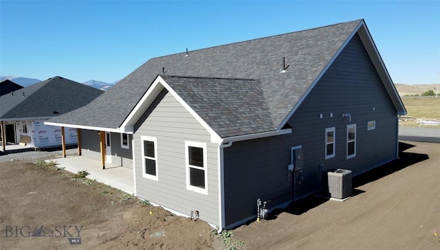 back of house featuring central air condition unit