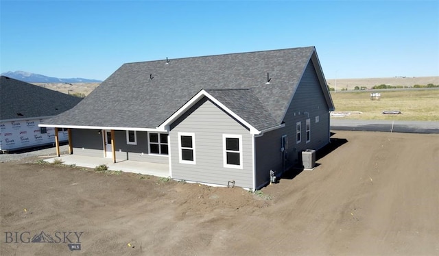 view of front of property featuring cooling unit and a mountain view