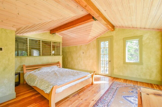 living room with vaulted ceiling, light hardwood / wood-style floors, wooden ceiling, and a wood stove