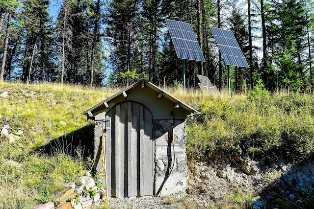 view of outbuilding featuring solar panels