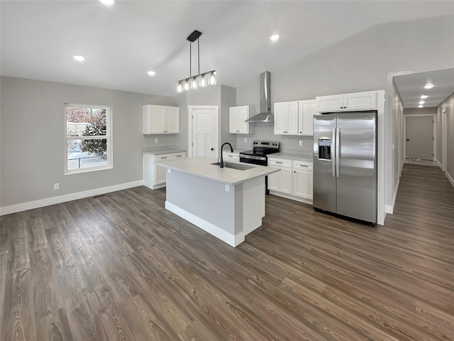 kitchen featuring wall chimney exhaust hood, sink, white cabinetry, pendant lighting, and stainless steel appliances