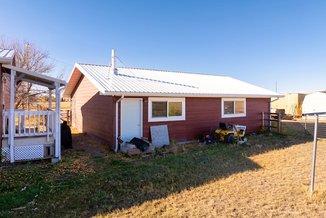 rear view of house featuring a lawn