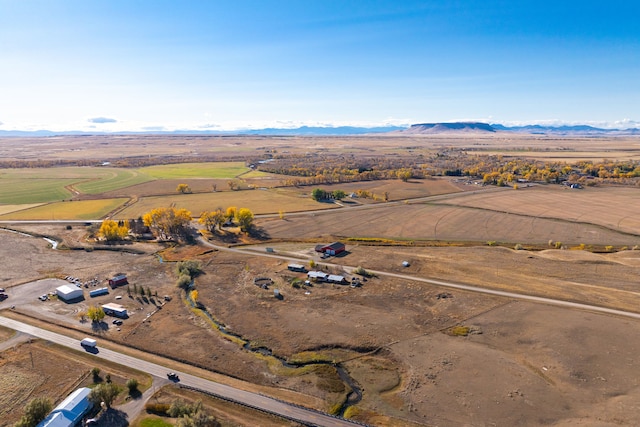 birds eye view of property with a mountain view and a rural view