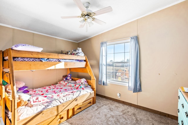 carpeted bedroom with crown molding, ceiling fan, and vaulted ceiling