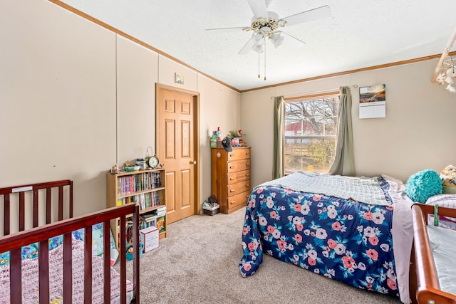 carpeted bedroom featuring ceiling fan, crown molding, and a textured ceiling