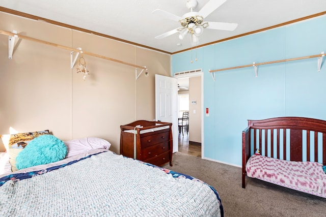 bedroom with crown molding, ceiling fan, and dark carpet