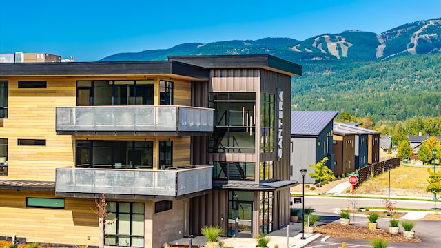 exterior space featuring a balcony and a mountain view