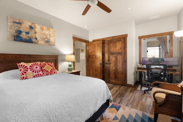 bedroom with ceiling fan and dark hardwood / wood-style floors