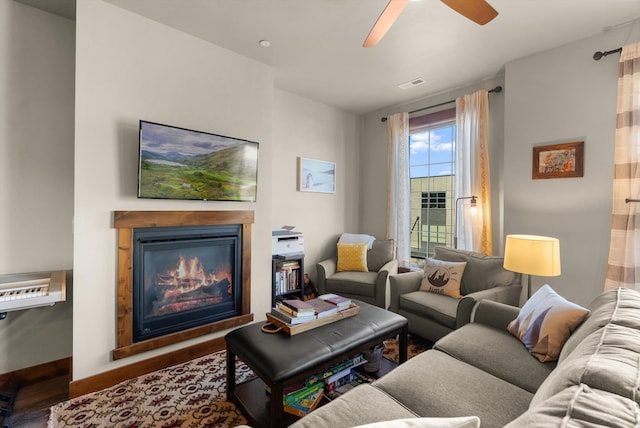 living room featuring ceiling fan and hardwood / wood-style floors